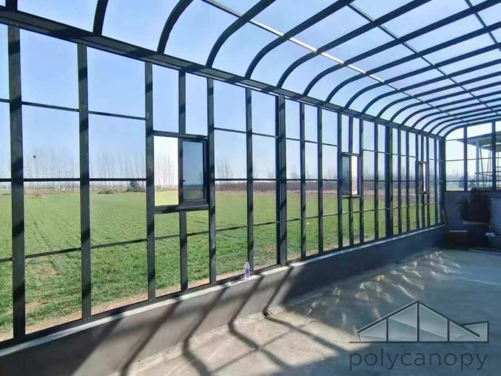 Modern Sunroom Fully enclosed arched sunroom with transparent panels and countryside view