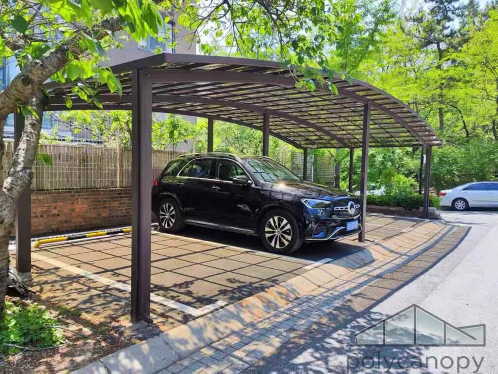 Residential Carport Modern residential carport with a curved transparent roof and luxury SUV parked underneath